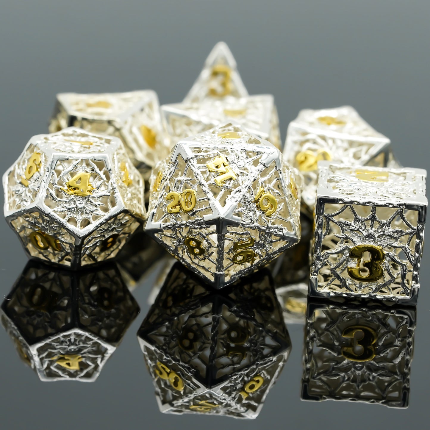 silver dice set made of hollow metal with gold numbers