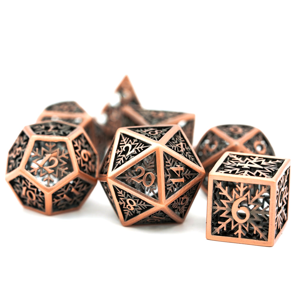 bronze snowflake metal hollow dice set with d20, d12 and d6 in the front