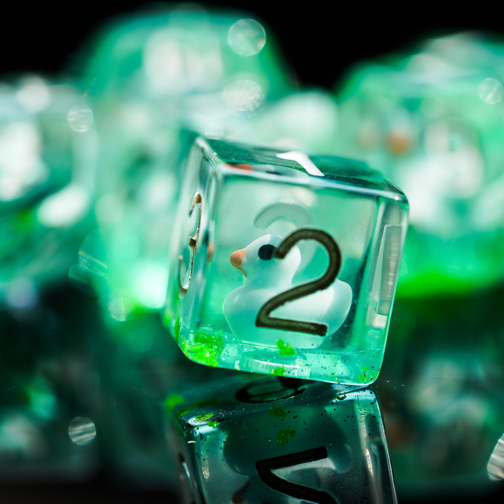 green transparent ducky dice, up close to show numbers and little friend inside