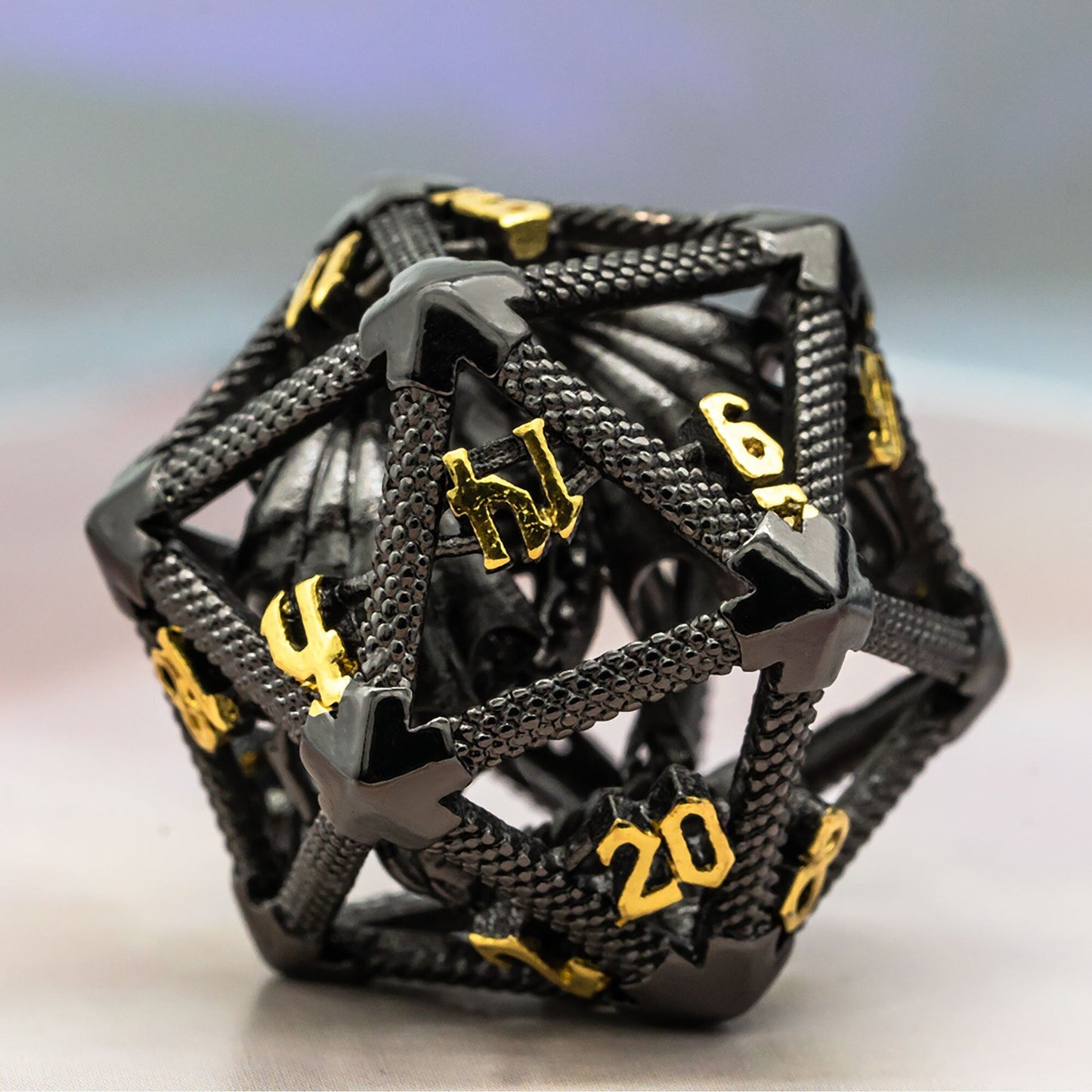 Black hollow metal d20 with gold numbers