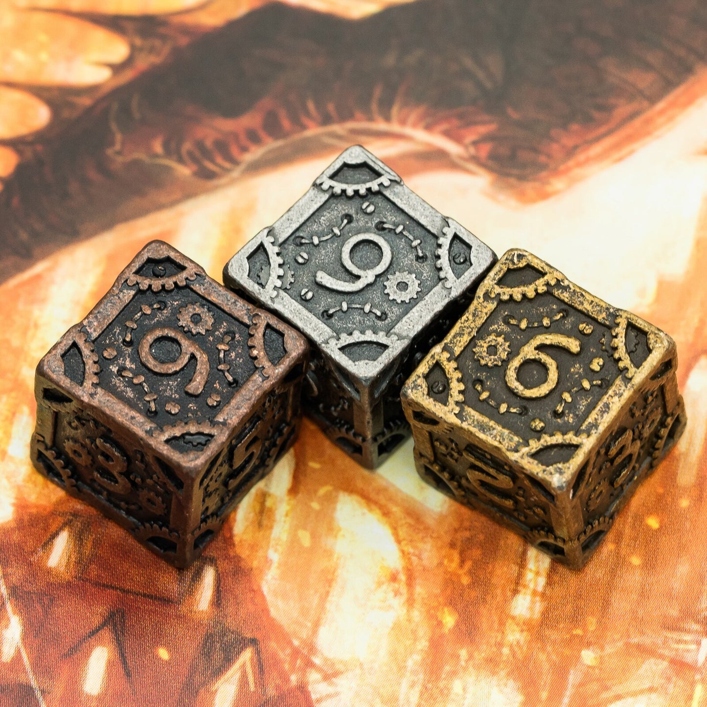 three d6s of bronze silver and gold coloring from steampunk dice sets