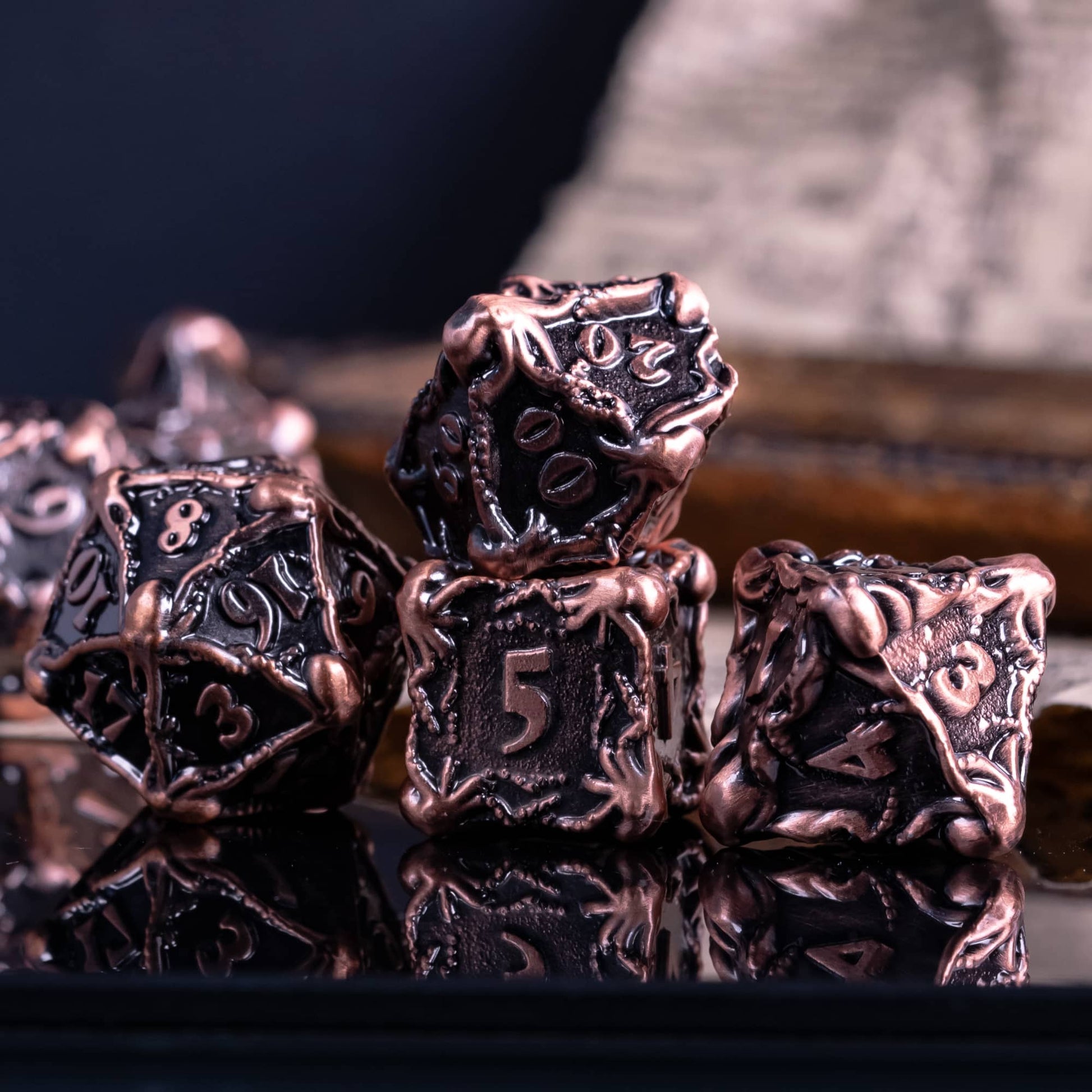 Dark metal octopus dice with blurry background