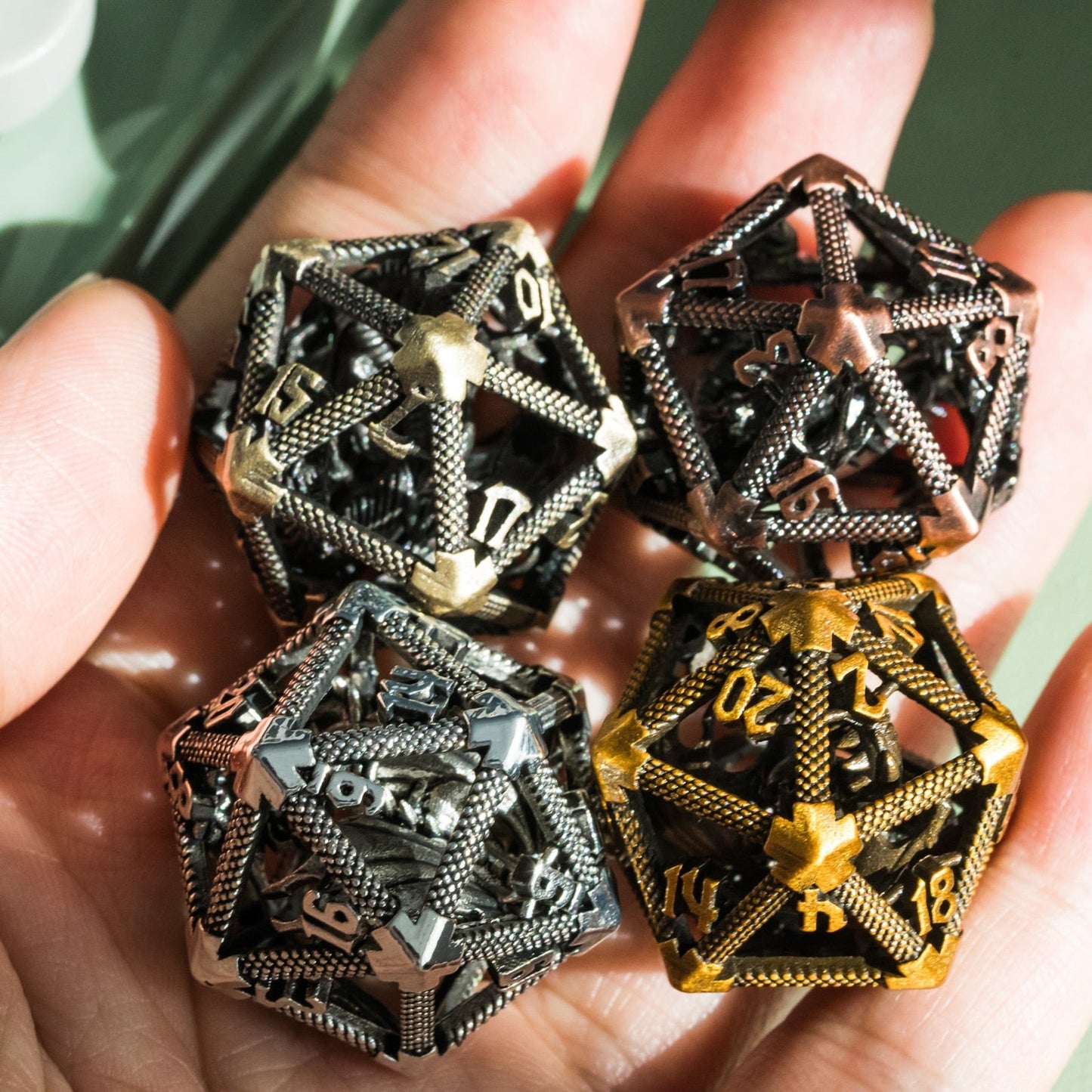 Set of four hollow metal d20s