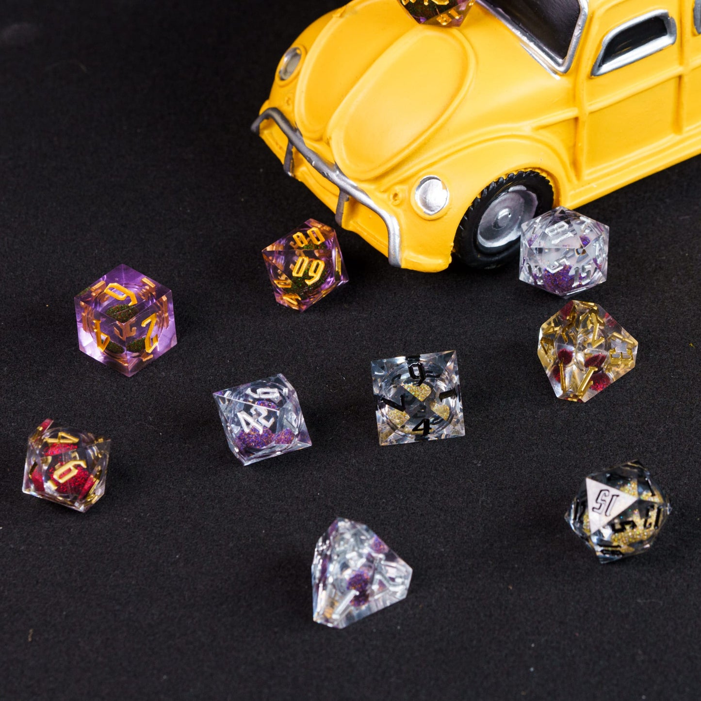 Variety of colors of quicksand dice with toy VW beetle