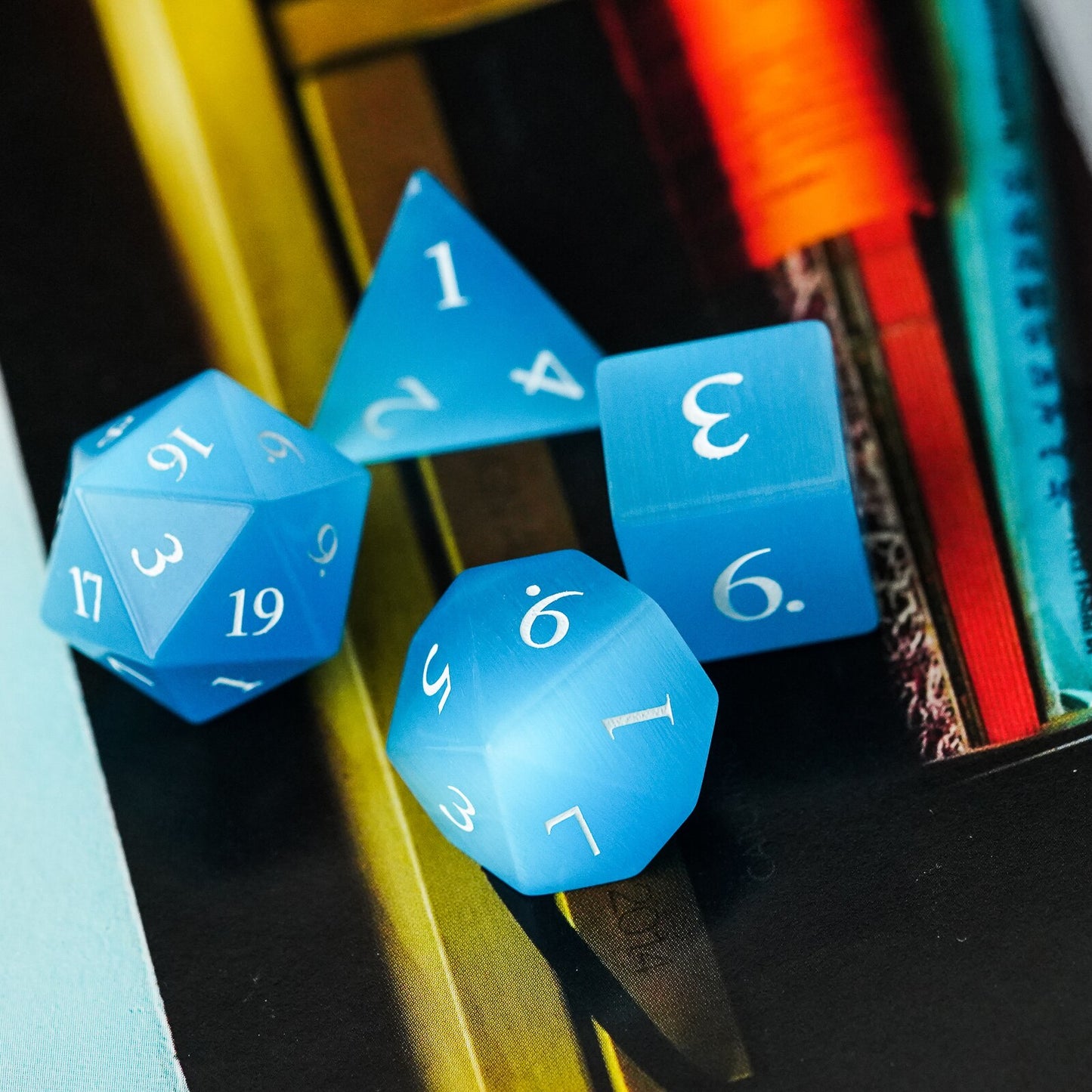 blue stone dice set on notebook