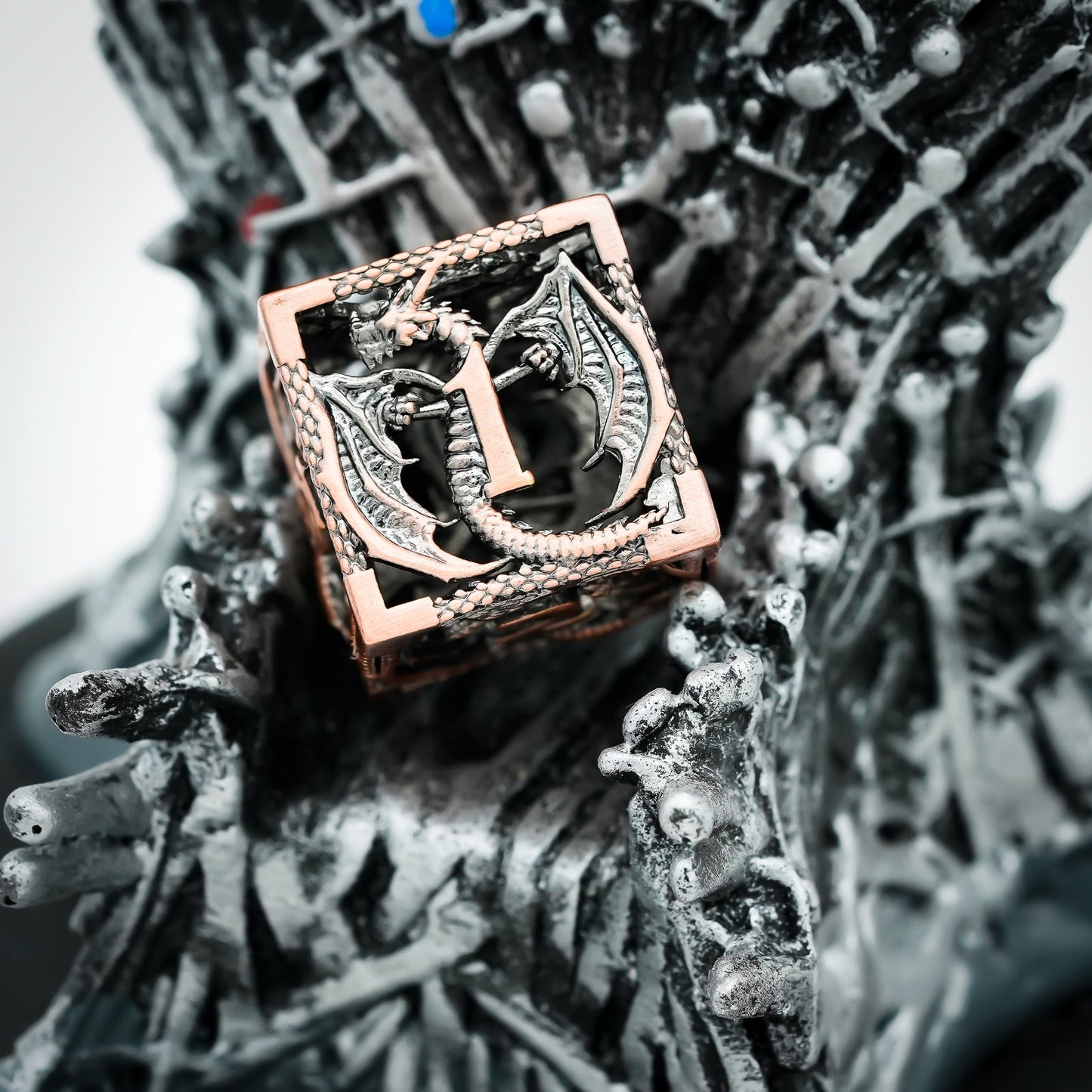 Ancient Copper Dragon hollow D6 dice resting on silver fantasy throne base