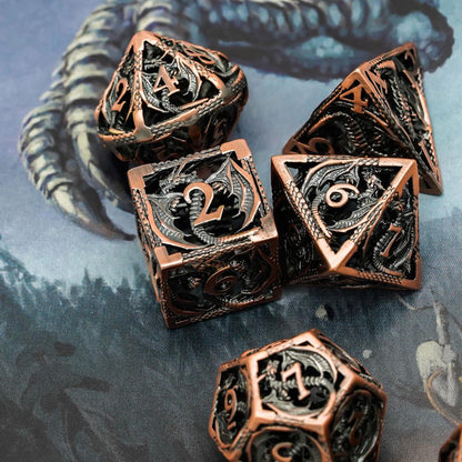 Copper hollow metal dice set displayed on fantasy dragon-themed mat