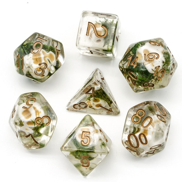 skull dice set with green moss on white background