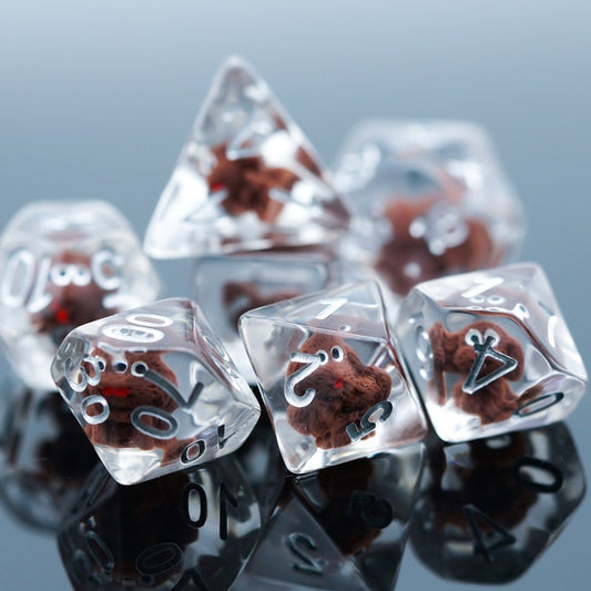 Transparent doggo dice set, 7 pieces. Cute brown puppies set in clear plastic with white numbers.