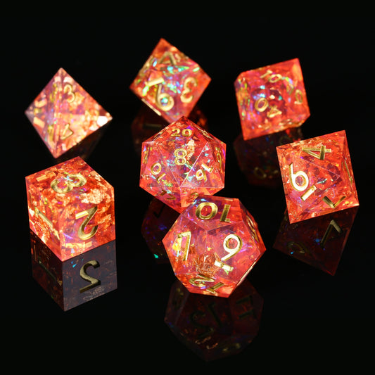 7 piece coral spark dice set, red with gold numbers on a black background