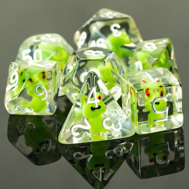 Transparent froggo 7 piece dice set. Green frogs set in clear plastic with white  numbers