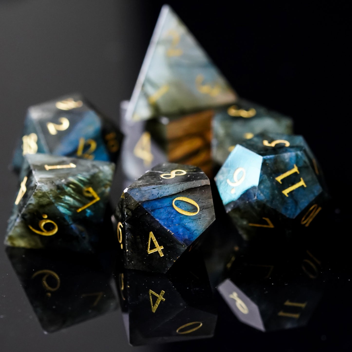 7 piece stone dice set, dark blue and black coloring with gold numbers