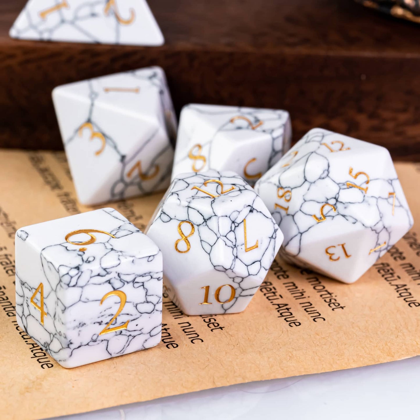 Cracked marble stone dice set sitting on page