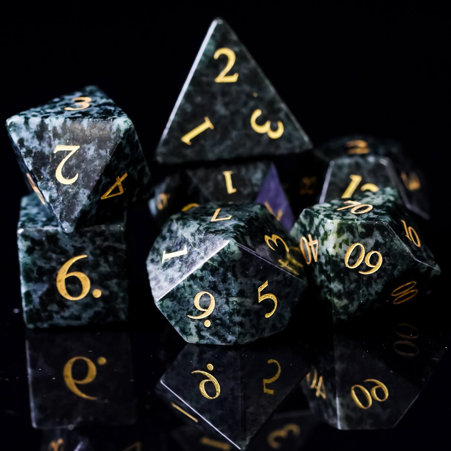 Seaweed Tangle stone dice set close-up of multiple polyhedral dice with gold numbers